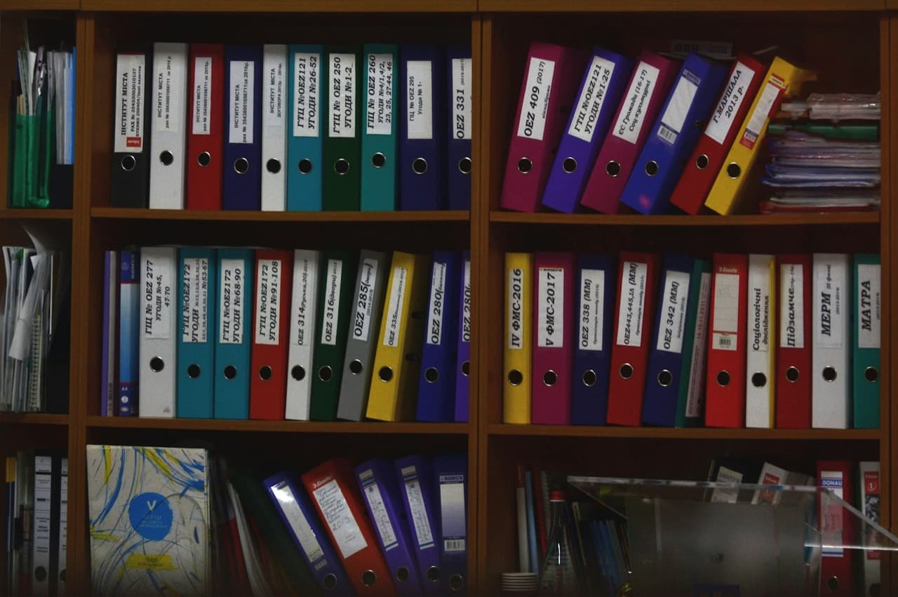 Organized files and binders representing automated document processing pipelines